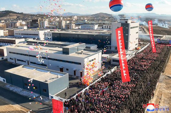 Aerial view of a North Korean industrial complex during an outdoor ceremony.
